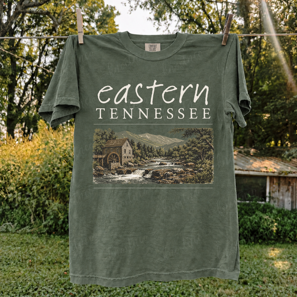 Eastern Tennessee Comfort Colors t-shirt featuring a vintage mountain landscape with a rustic mill, river, trees, and Appalachian scenery, also available as a Gildan sweatshirt plus size available